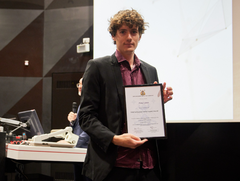 Pieter Lamb poses with his social impact award
