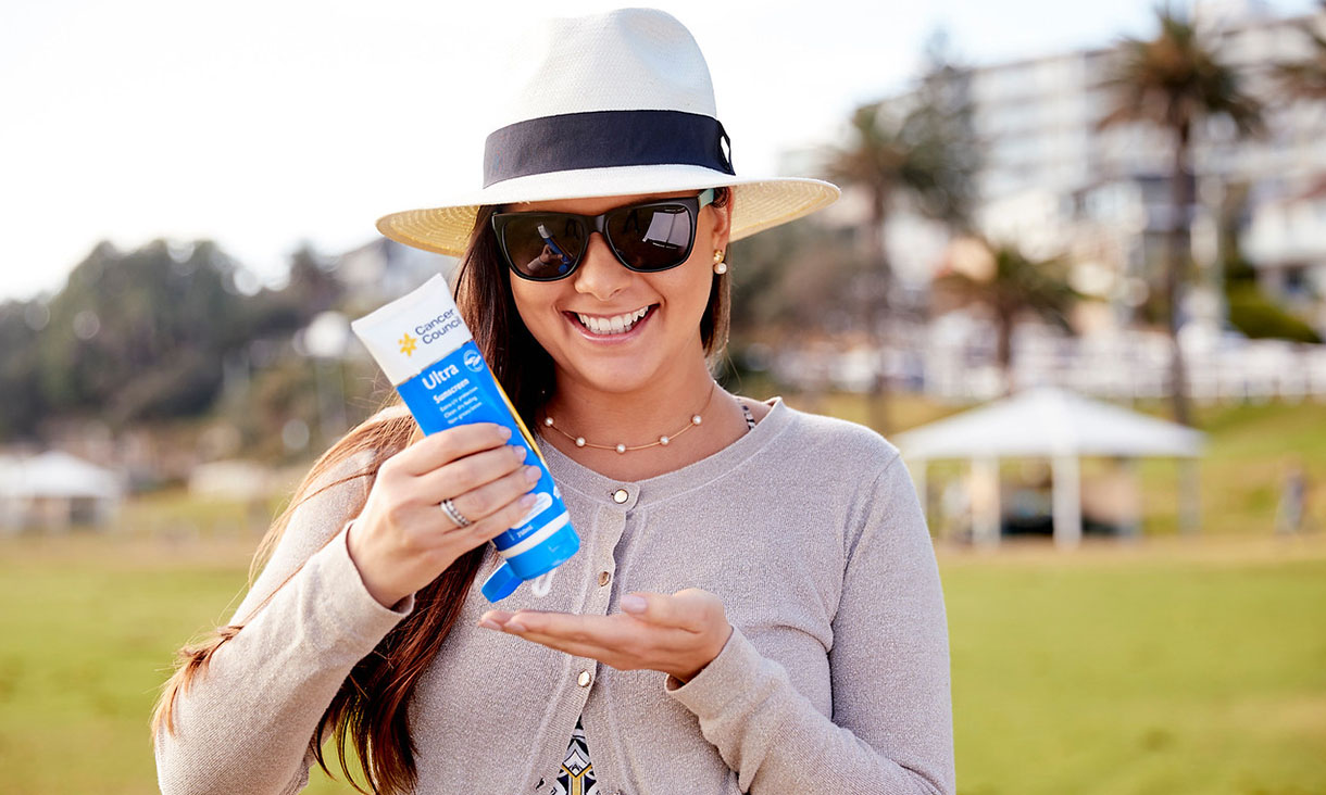A woman wearing sunscreen. In Australia’s harsh UV environment, sunscreen is an essential form of sun protection.  Credit: Cancer Council Australia