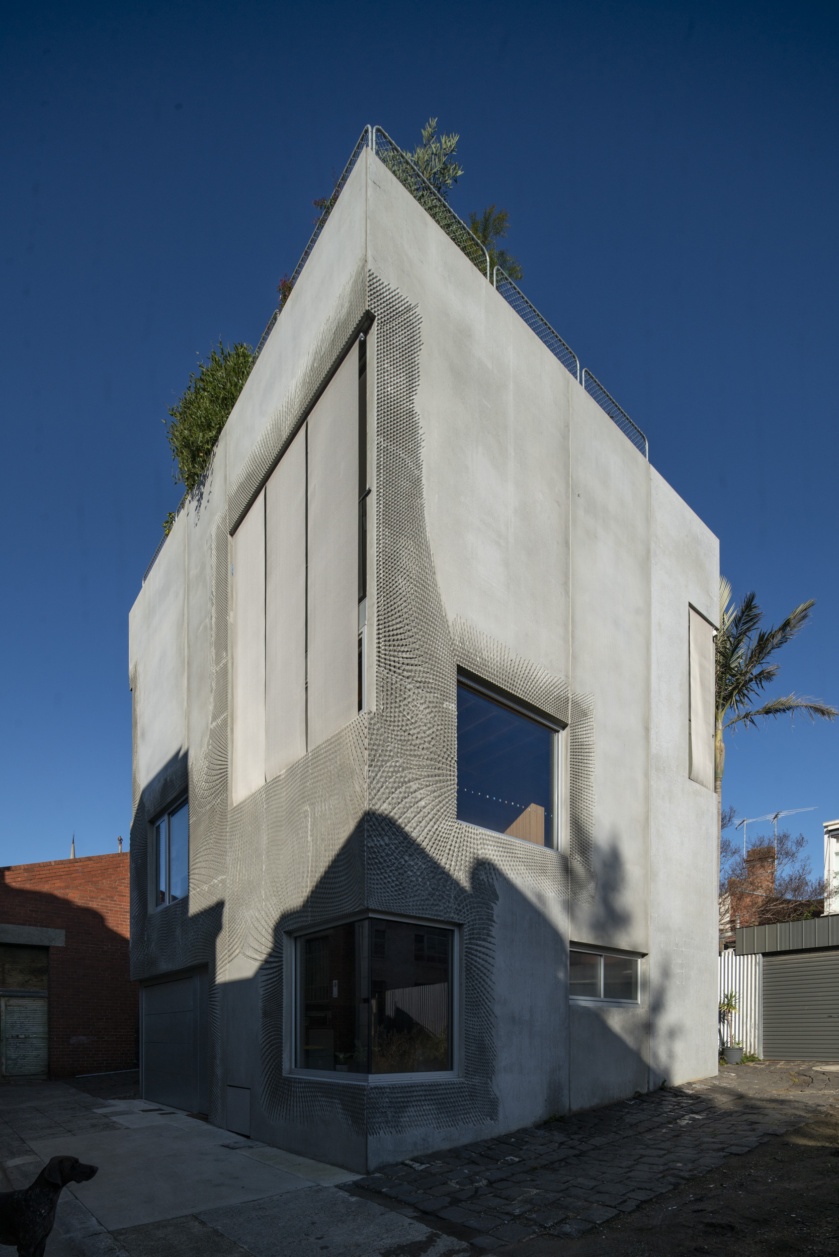 The completed 3-story concrete house with a roof garden