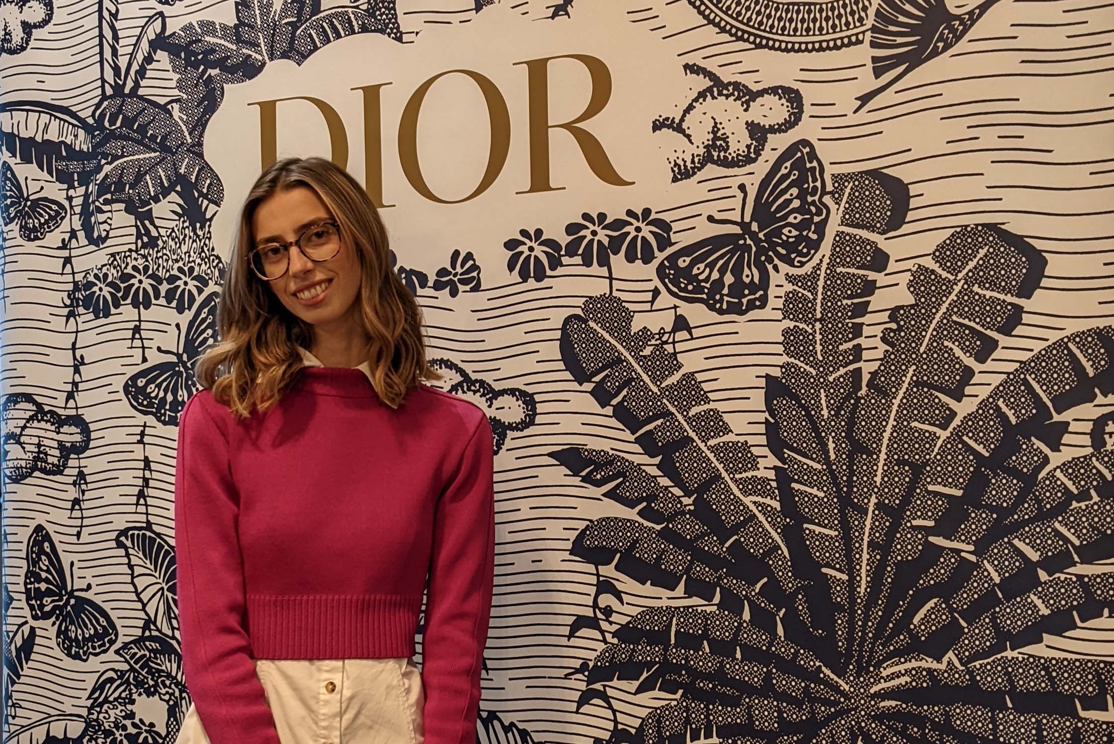 Photo of Ellie Barclay in front of Dior sign