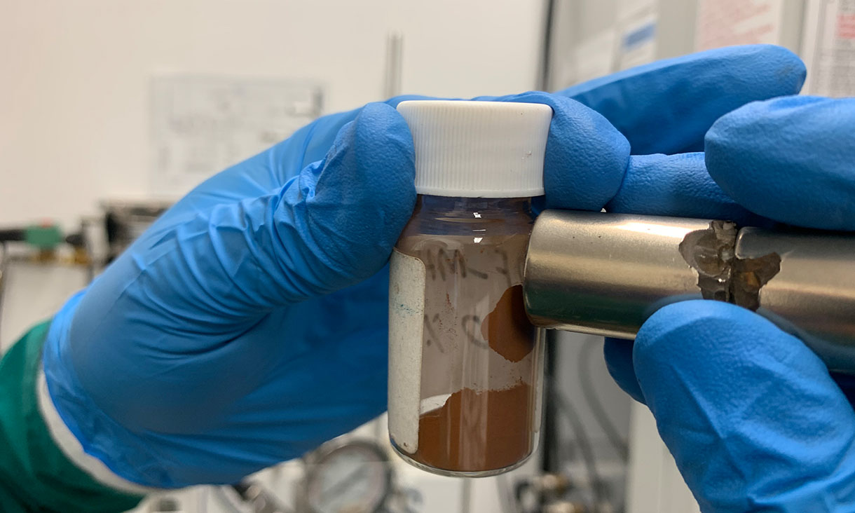 A magnet attracts the material that the team used to make adsorbents that remove microplastics and dissolved pollutants from water. Credit: RMIT University