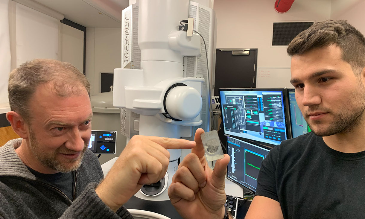 Monash University Professor Andy Tomkins (left) with RMIT University PhD scholar Alan Salek holding a ureilite meteor sample at the RMIT Microscopy and Microanalysis Facility. Credit: RMIT University