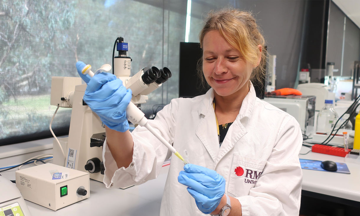 Dr Céline Valéry using a pipette to inject a gel into a vial.