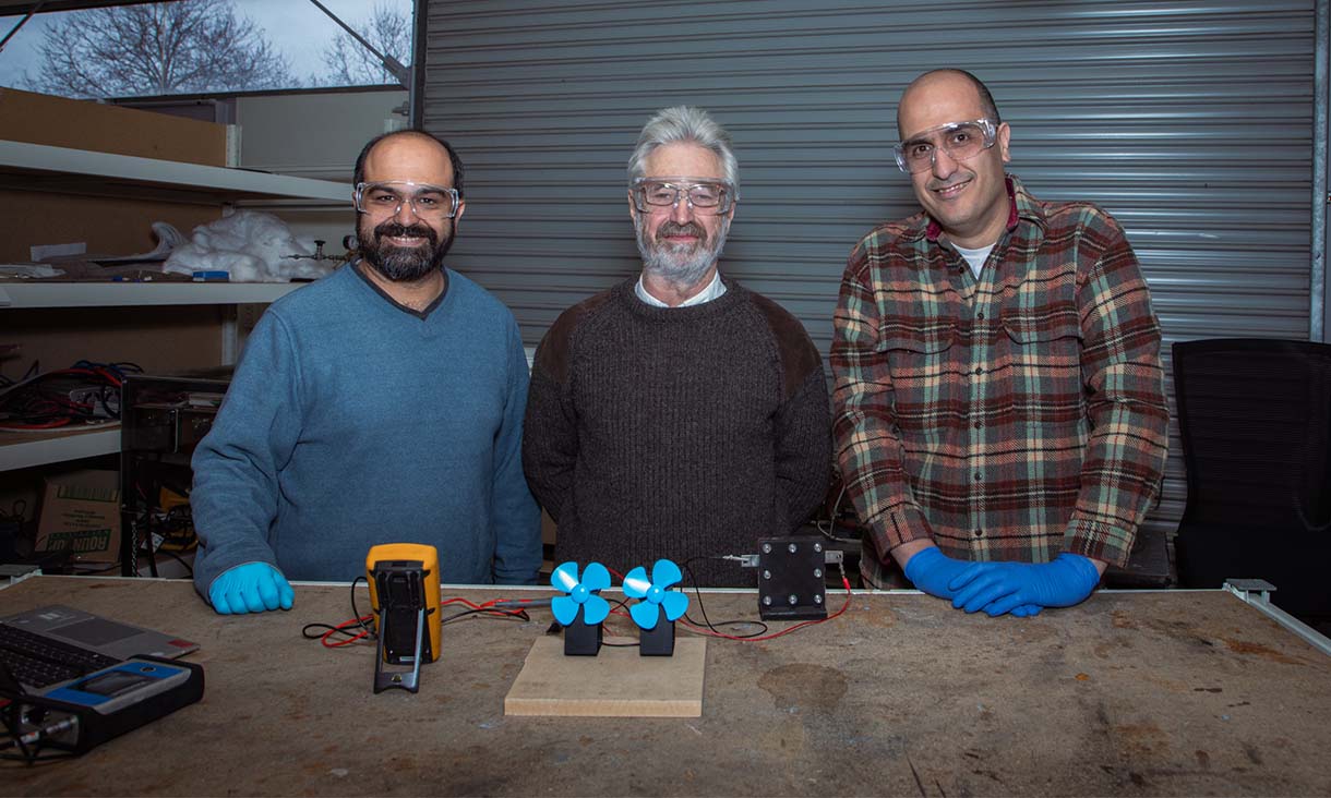 Dr Shahin Heidari (left), Professor John Andrews and Dr Seyed Niya with a demonstration of the proton battery operating two small fans in the RMIT lab. Credit: RMIT University