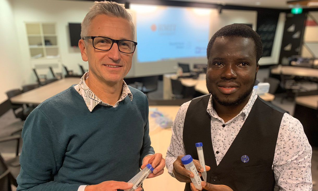 Dr David Bergmann and PhD researcher Ibrahim Hakeem holding samples of heavy metals removed from biosolids. Credit: RMIT University