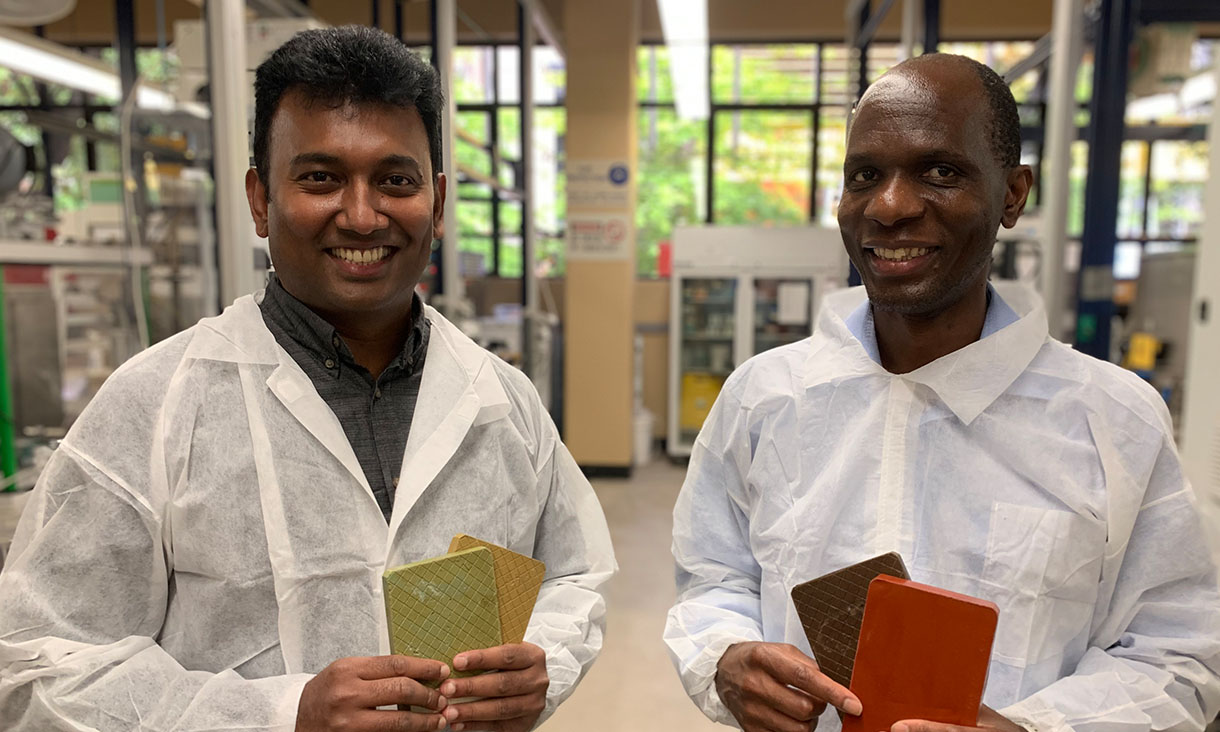 Associate Professor Dilan Robert (left) and Associate Professor Everson Kandare with cladding samples made with recycled glass and other materials. Credit: RMIT University