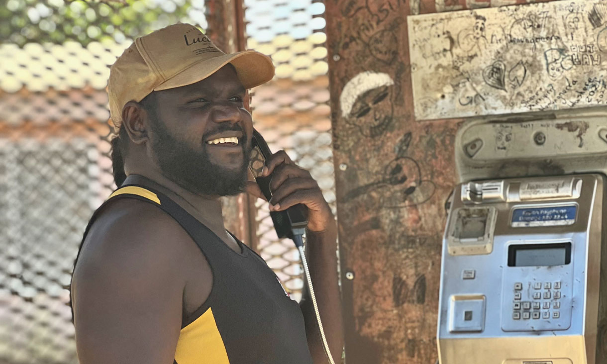 Gangan co-researcher Djamika Ganambarr uses the public phone which is the primary means of phone communication for most Gangan residents.