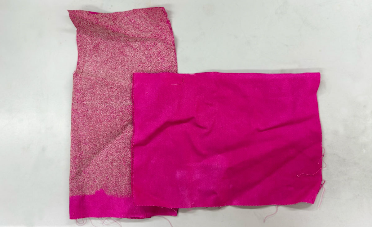 A sample of pink cotton fabric that’s been treated with nanodiamonds (left) next to untreated cotton (right).