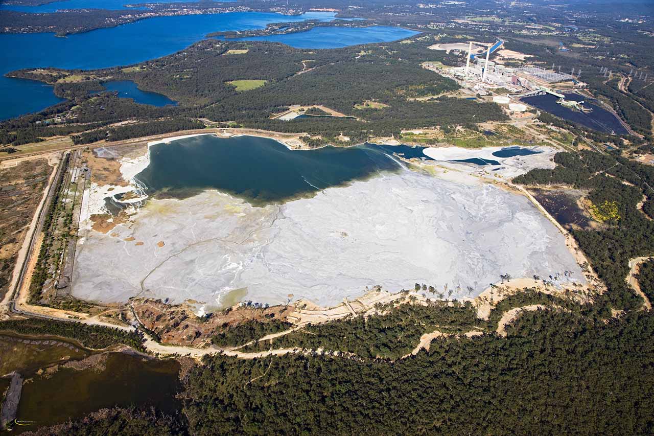 Eraring Power Station and ash dam from above, with Lake Macquarie in the background. Supplied: Ash Development Association of Australia.