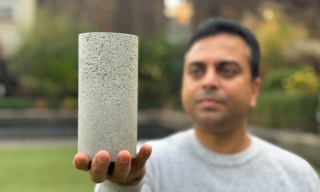 Dr Chamila Gunasekara holds a sample of the low-carbon concrete. Credit: Michael Quin, RMIT.