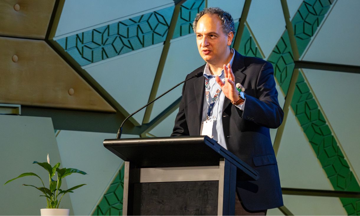 Associate Professor Jonathan Kolieb presenting at lectern.