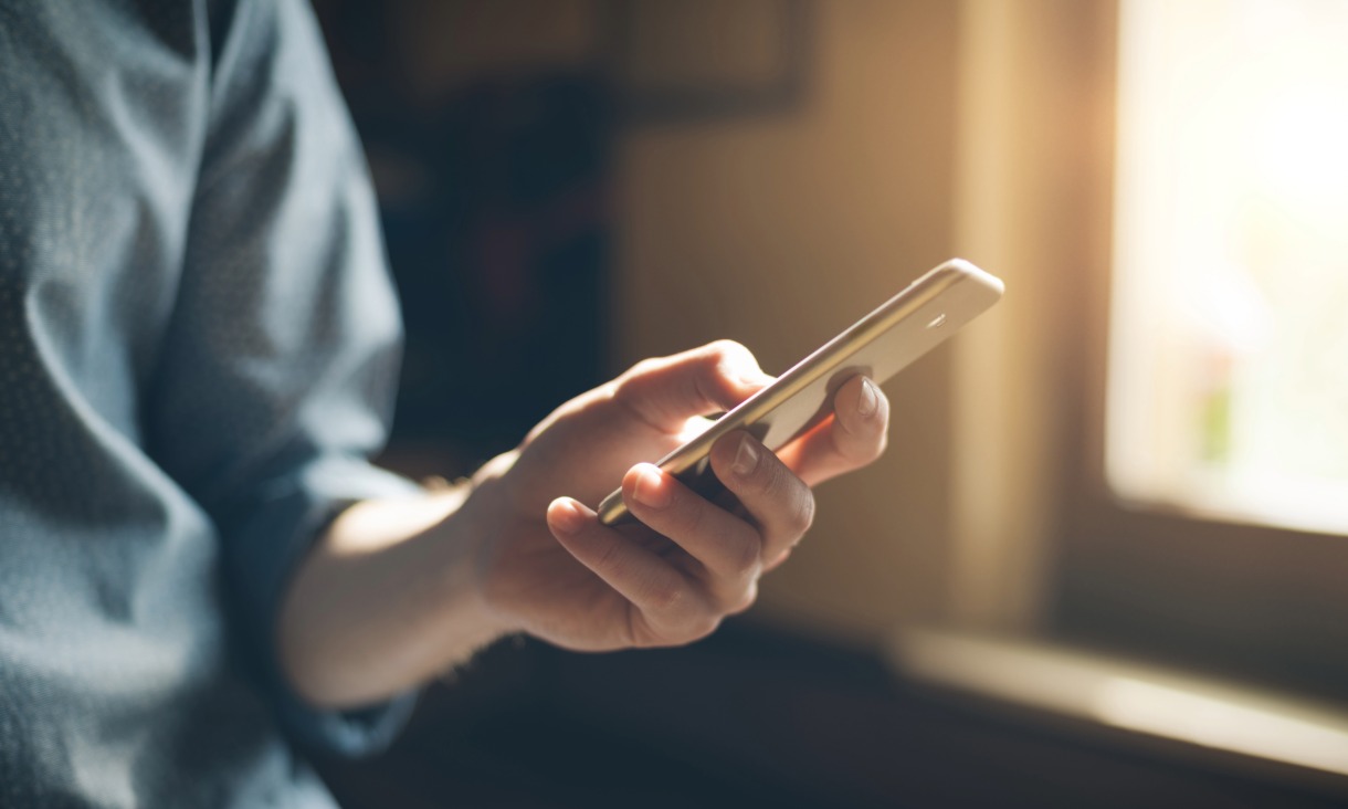 Phot of person using a mobile phon.