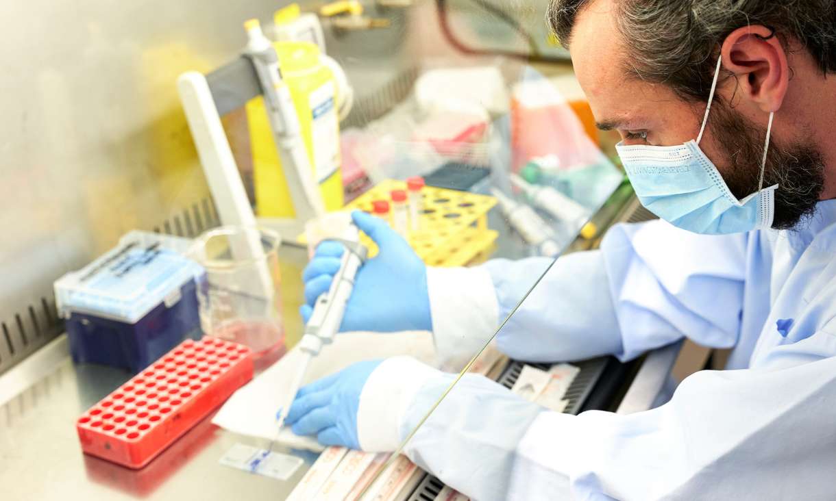 Person in lab using pipette