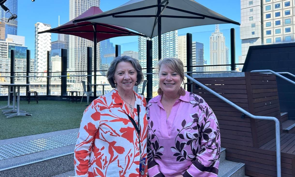 RMIT School of Education representatives Kathy and Simone stand together smiling.