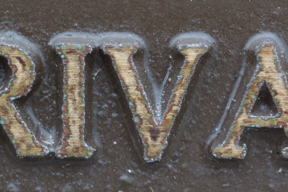Close up of bronze corrosion of a commemorative plaque