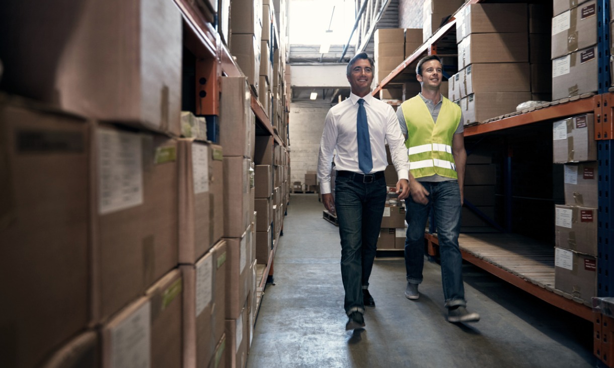 Supply chain professionals walking through warehouse