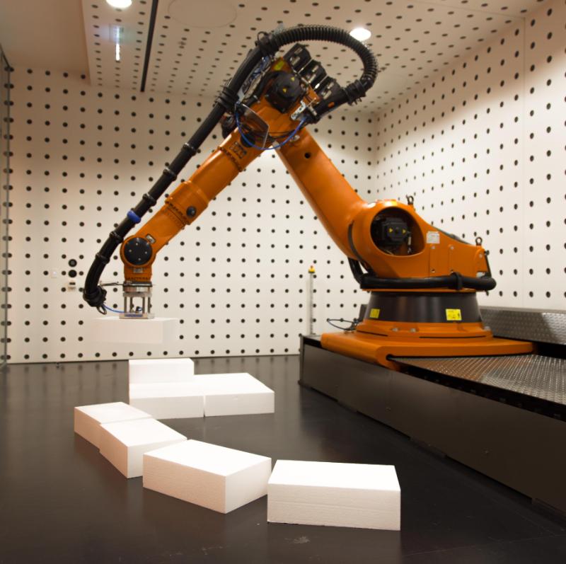 A robotic armed machine moving large rectangles