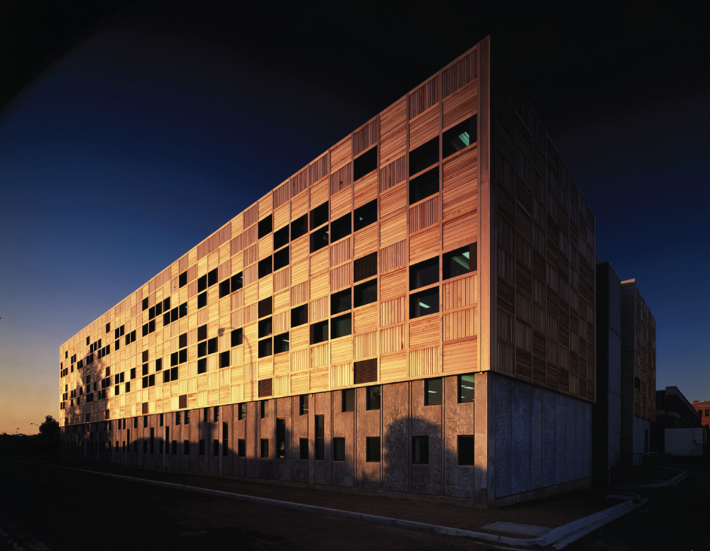 An RMIT building lit up by the sun at sunset