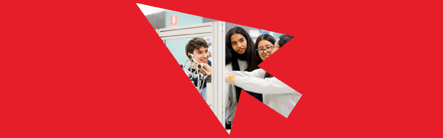 Group of people collaborating around a computer display in a vibrant red geometric design.
